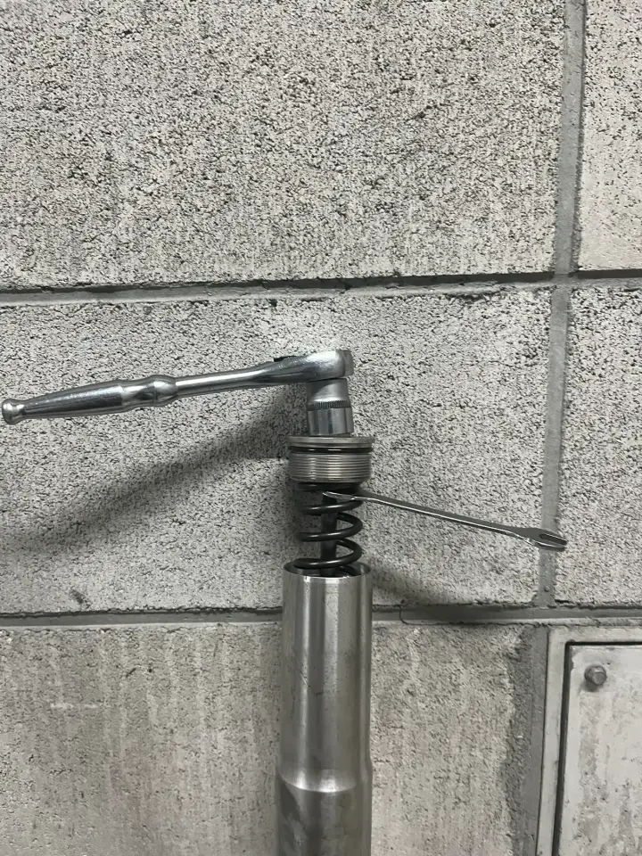 13mmレンチを使ってトップキャップを外している様子